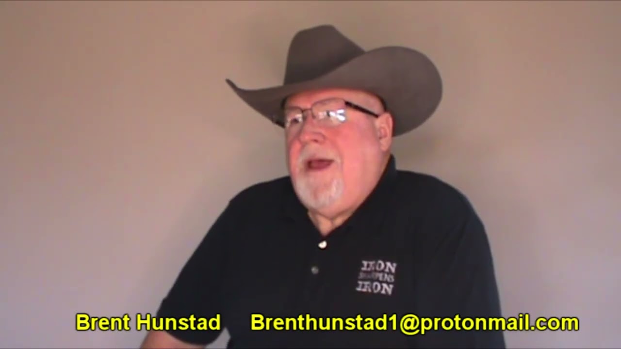 Person in cowboy hat speaking indoors.